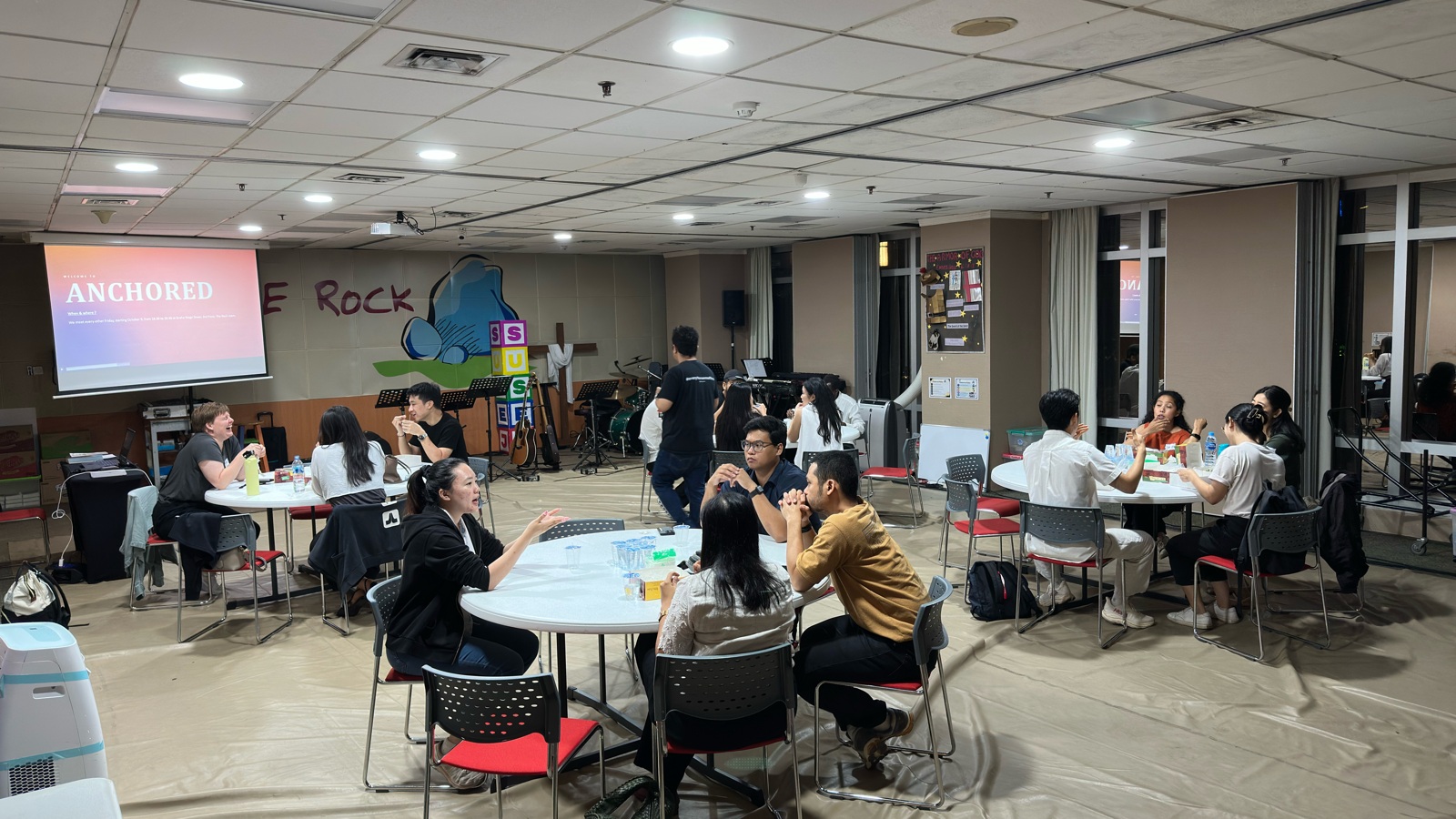 Young Professionals gathering for discussion and fellowship in The Rock Room at JICF